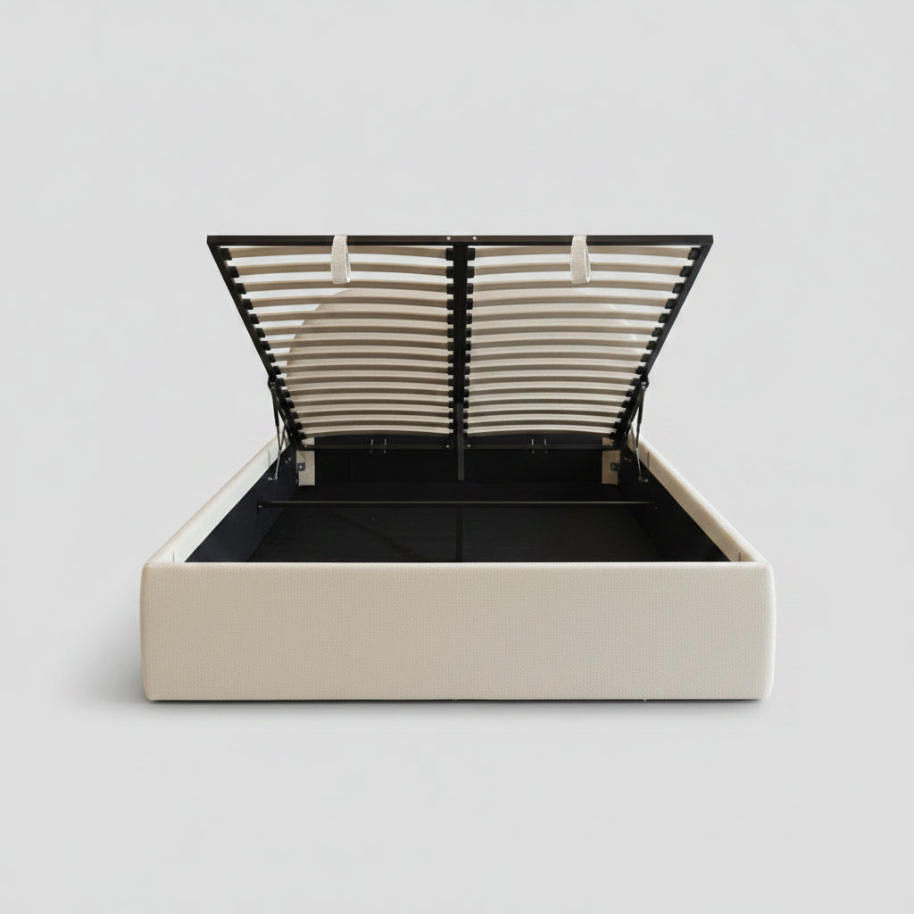 A smart lift-up storage bed frame by Placida Decor, shown open to reveal spacious under-bed storage. The bed frame is cream-colored with a black metal support structure and slatted lid.