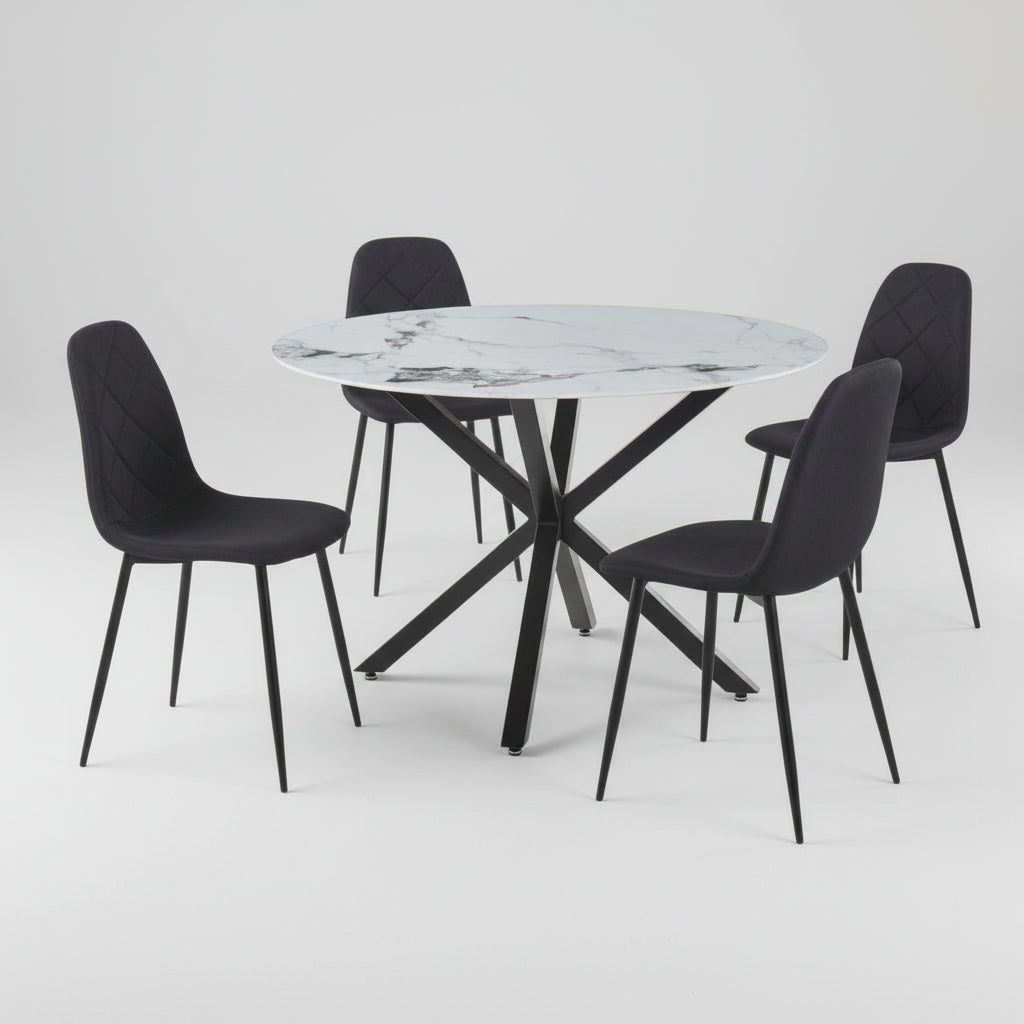 Round marble table with four black chairs on a white background