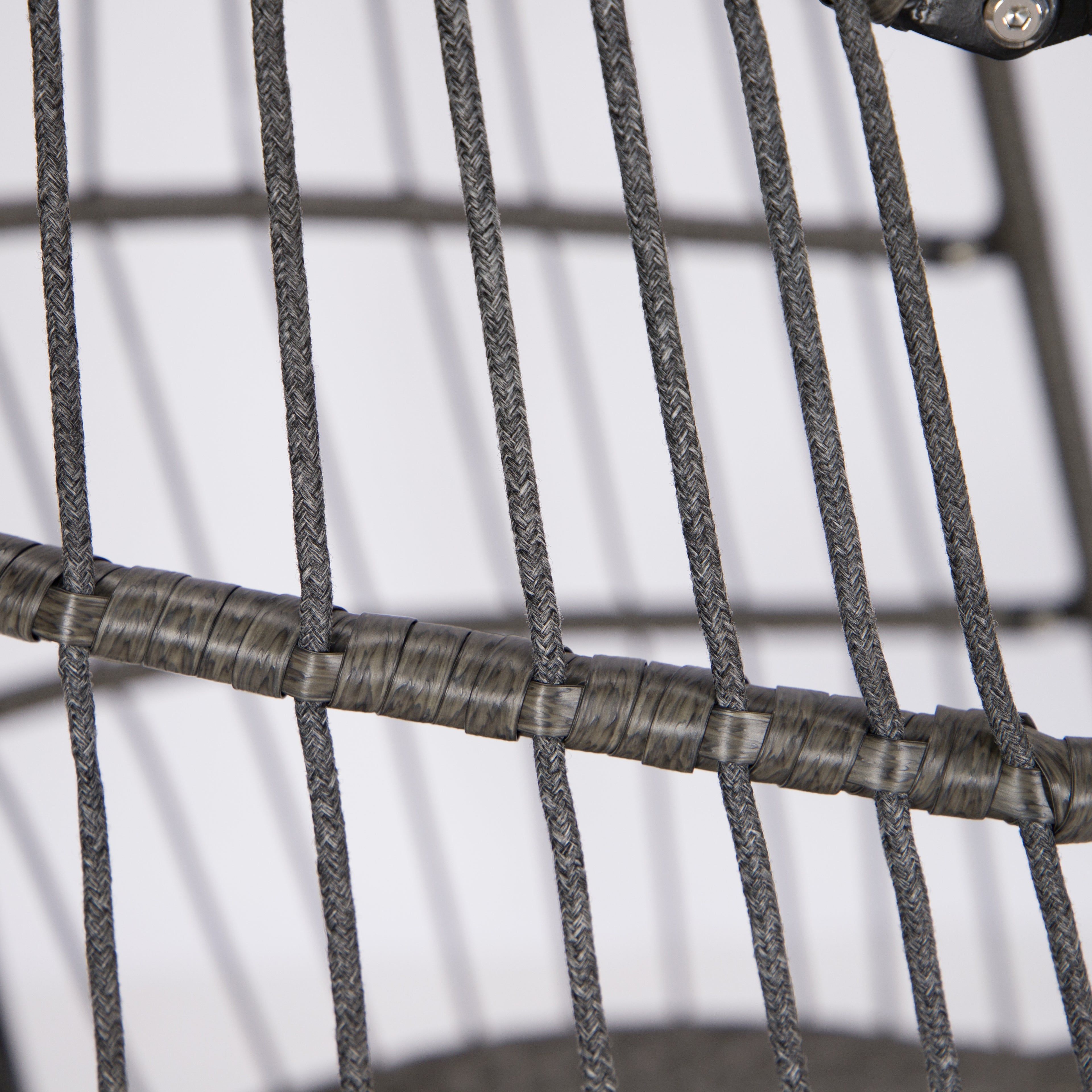 Close-up of a woven wire chair with a plain background