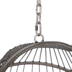 Close-up of a hanging chair with metal chain and woven design on a white background
