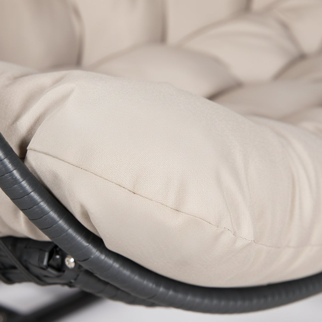 Close-up of a beige cushion on a chair with a blurred background