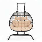 Hanging egg chair with beige cushions on a white background