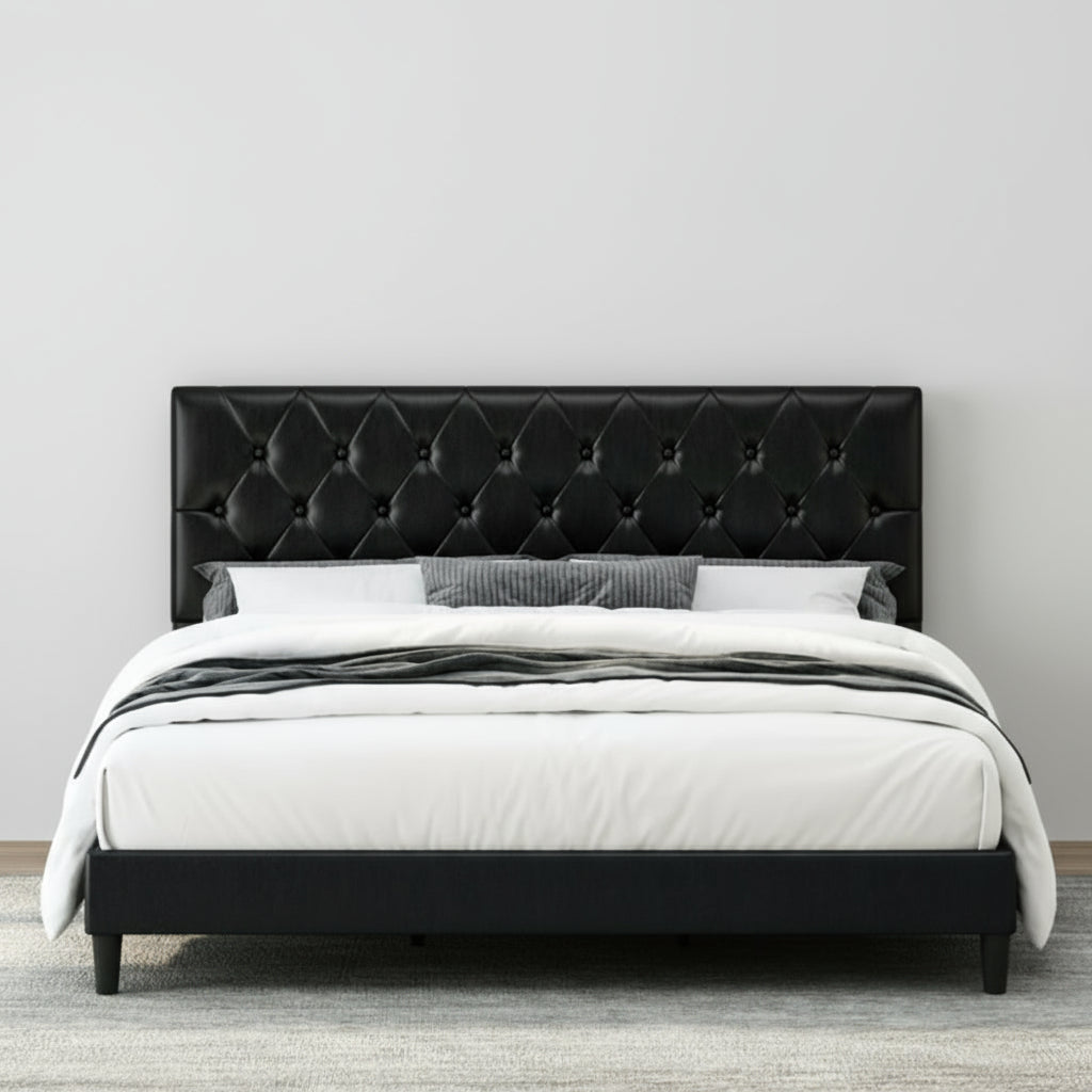 Black tufted bed with white bedding in a bedroom setting