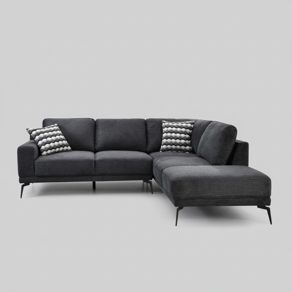 Gray sectional sofa in a living room with decorative pillows and a lamp.