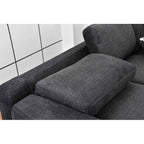 Gray fabric sofa with a white tiled wall background