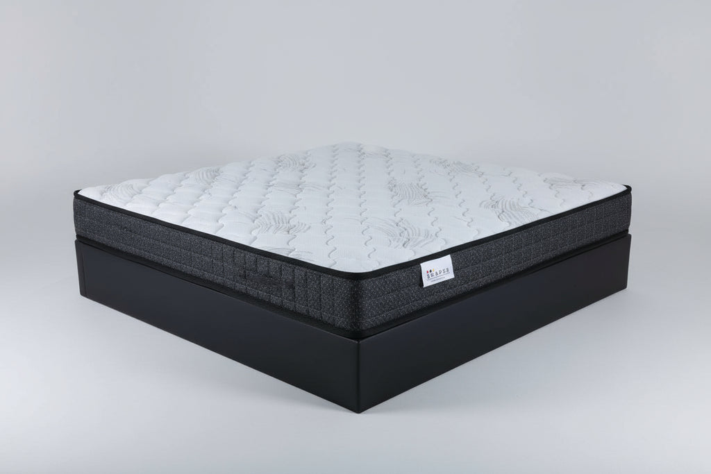 Mattress with a brand label on a dark surface