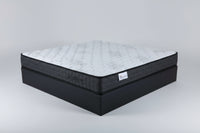 Mattress with a brand label on a dark surface