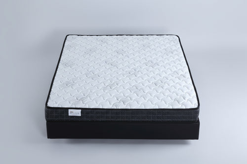 Mattress on a bed in a bedroom setting with a neutral color scheme.