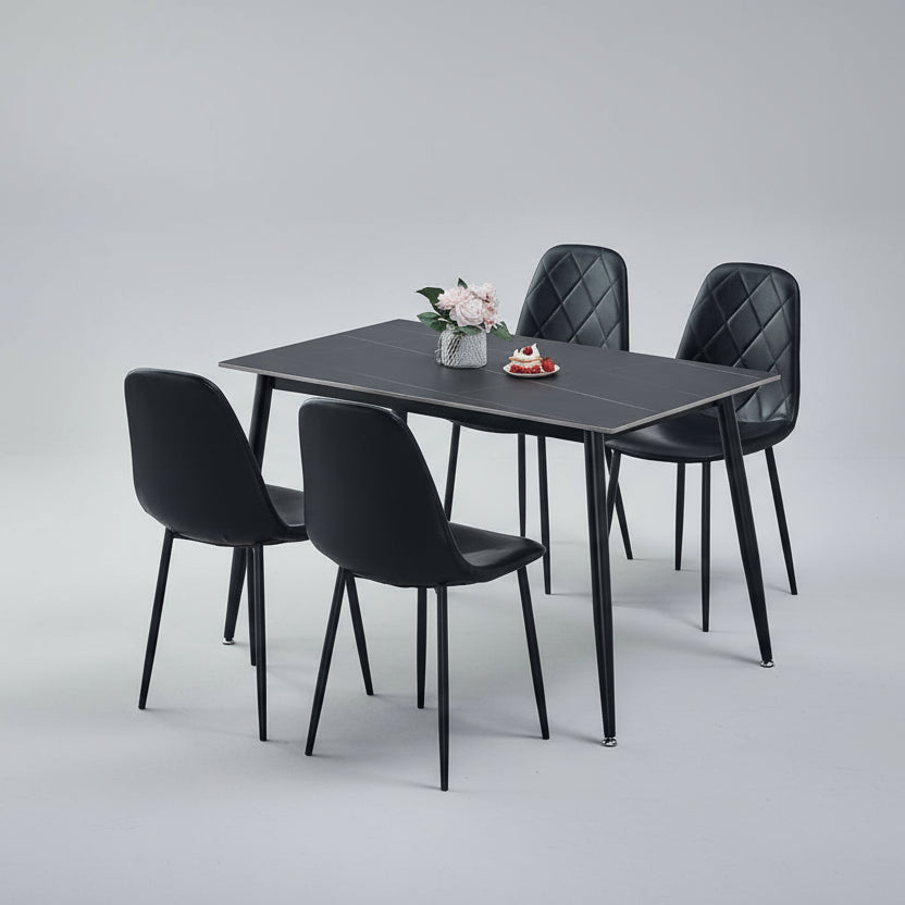 Dining set with a table and four chairs in a room with a rug and window.