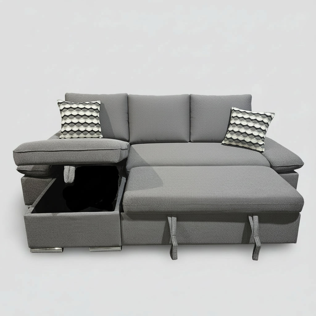 Gray sectional sofa with a coffee table extension in a room with plants and artwork.