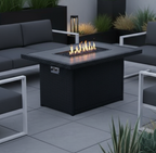 Outdoor patio setup with black furniture, fire pit, and plants on a rooftop.
