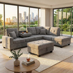 Gray sectional sofa with beige accents in a modern living room with city skyline view.
