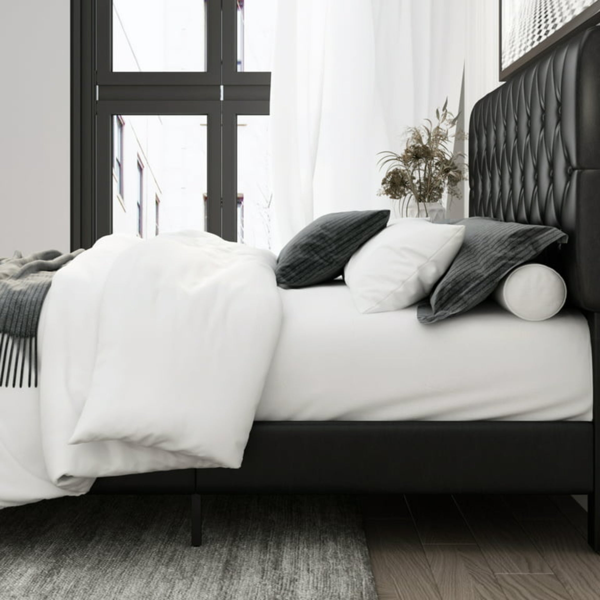 Bedroom with a bed featuring white bedding and dark headboard.