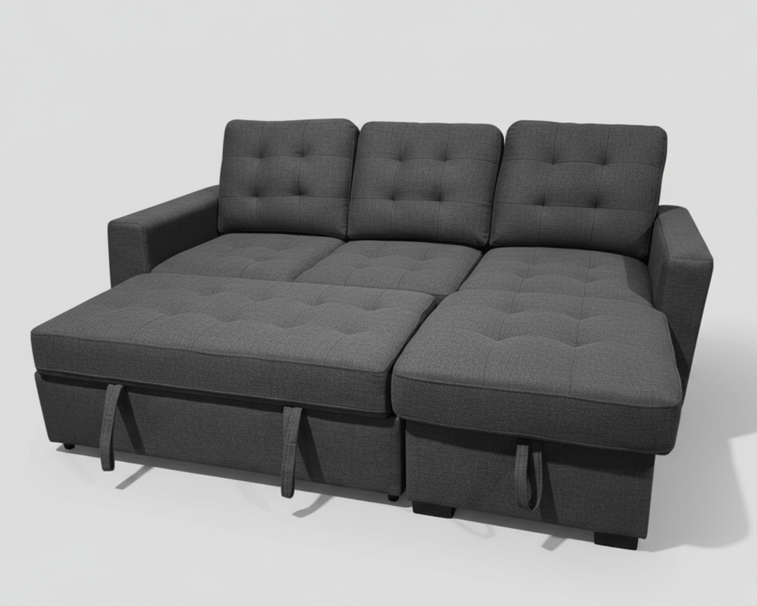 Gray sectional sofa in a room with plants and a wooden floor.