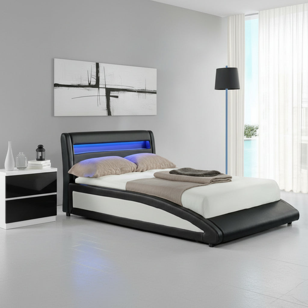 Modern bedroom with a black and white bed, abstract painting, and lamp.