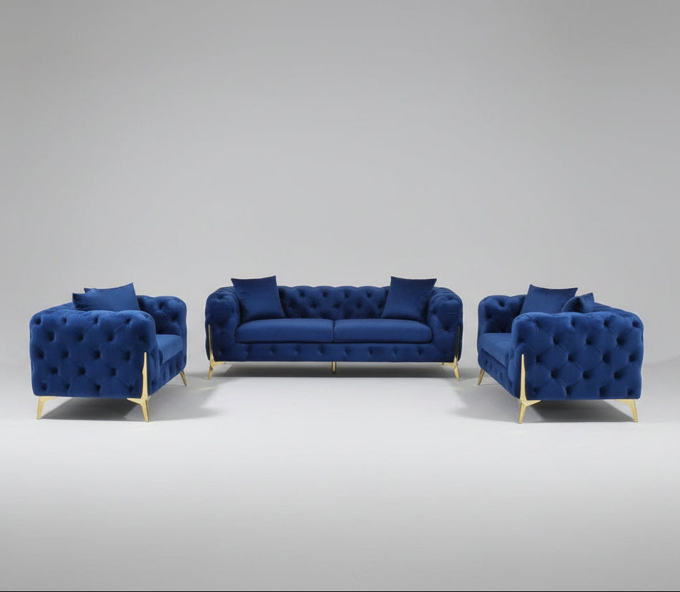 Set of blue sofas on a gray floor with curtains in the background