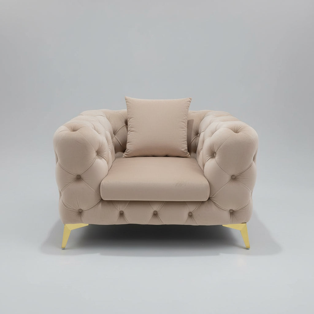 Beige armchair with tufted backrest and gold legs in a room setting